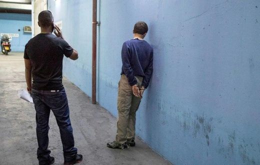 American-Israeli Jewish teenager (R) accused of making of anti-Semitic bomb threats in the US and elsewhere, is escorted outside the Israeli Justice court in Rishon Lezion