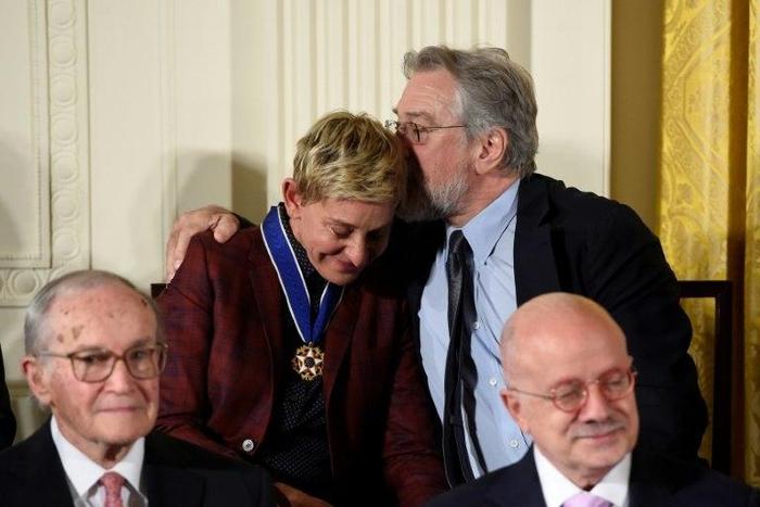 US actor Robert De Niro (R) hugs actress and comedian Ellen DeGeneres after she was presented with the Presidential Medal of Freedom, at the White House