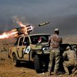 Soldiers from the Iraqi army's 9th Division fire a multiple rocket launcher from a hill in Talul al-Atshana, on the southwestern outskirts of Mosul