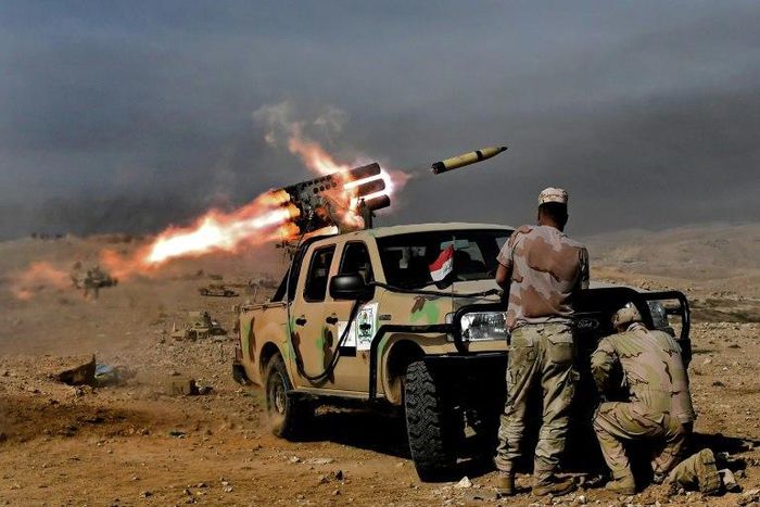 Soldiers from the Iraqi army's 9th Division fire a multiple rocket launcher from a hill in Talul al-Atshana, on the southwestern outskirts of Mosul