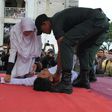 An Acehnese man collapses as he is caned by a religious officer in Banda Aceh on 27th February 2017