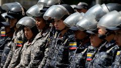 Members of the Bolivarian National Police stand guard in Caracas, during a protest against the government of President Nicolas Maduro on January 30, 2019