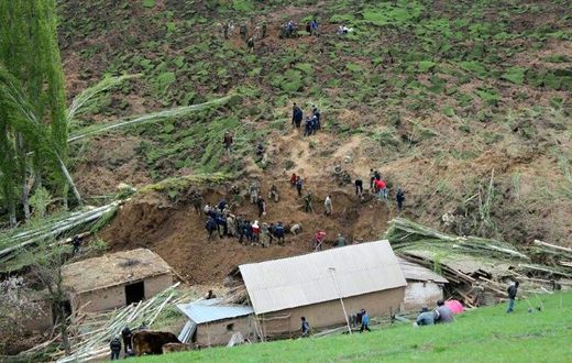 A handout picture taken on April 29, 2017 and provided by the Kyrgyz Red Crescent Society press service shows rescue workers and soldiers working at the site of a landslide in the village of Ayu in Kyrgyzstan's Osh region