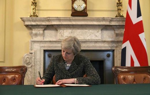 Britain's Prime Minister Theresa May signs a letter to European Council President Donald Tusk invoking Article 50 and signalling the UK's intention to leave the EU, in the cabinet office inside 10 Downing Street on March 28, 2017