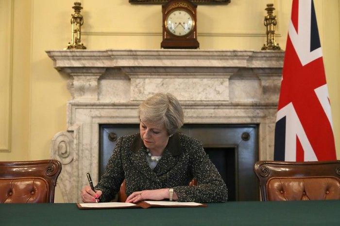 Britain's Prime Minister Theresa May signs a letter to European Council President Donald Tusk invoking Article 50 and signalling the UK's intention to leave the EU, in the cabinet office inside 10 Downing Street on March 28, 2017
