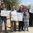 Residents of Khan Sheikhun in northern Syria hold placards and pictures on April 7, 2017 during a protest condemning a suspected chemical weapons attack on their town earlier this week that killed at least 87 people
