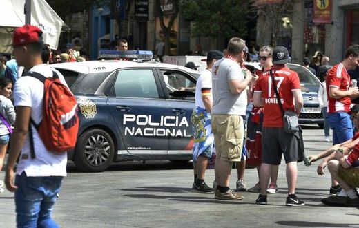 A police car patrols past Bayern supporters in the the Plaza del Sol before the Champions League quarter-final second leg at the Santiago Bernabeu stadium in Madrid on April 18, 2017
