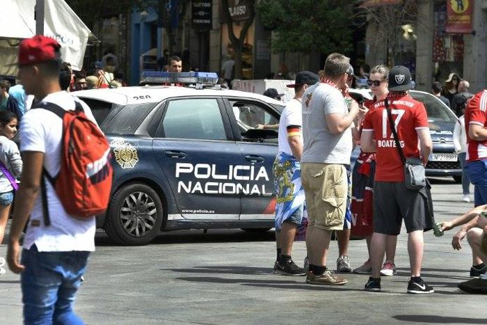 A police car patrols past Bayern supporters in the the Plaza del Sol before the Champions League quarter-final second leg at the Santiago Bernabeu stadium in Madrid on April 18, 2017