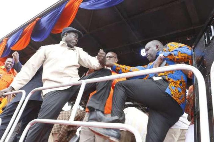 Hon Kaluma (left) and rival Washington Ogaga engage in a fist fight before a charged crowd at the Homa Bay Stadium.