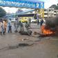 Police and county government askaris remove bonfires lit by traders protesting their eviction at Buxton in Mombasa.