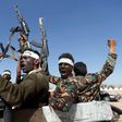 Newly recruited Houthi fighters chant slogans as they ride a military vehicle during in the Yemeni capital Sanaa on January 3, 2017