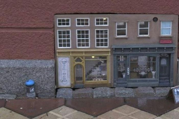 Built into a building's air vent at pavement level, the two little pastel-coloured storefronts are the altest installation from the artist's collective Anonymouse