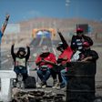 Miners of the Escondida copper mine, on strike, blocking a road outside of Escondida, some 145 km northeast of Antofagasta, Chile, on March 8, 2017