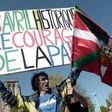Jean-Baptiste Redde or " Voltuan", a well-known protester in France for his placards, holds a sign reading: "Historic April 8, the courage of peace" at a rally in Bayonne