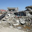 Iraqis inspect the rubble of destroyed houses in the Mosul al-Jadida area, following air strikes in March 2017