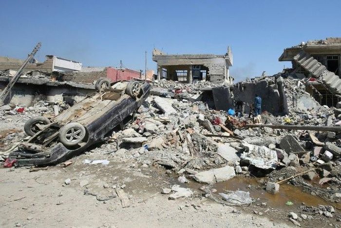 Iraqis inspect the rubble of destroyed houses in the Mosul al-Jadida area, following air strikes in March 2017