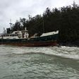 A vessel sits on the rocks after running aground near the Whitsunday Islands during Cyclone Debbie