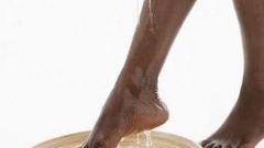 An African woman cleaning her feet