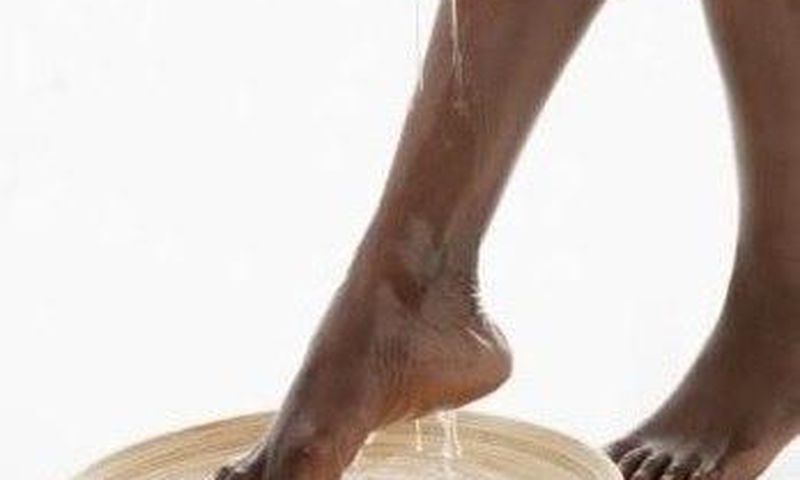 An African woman cleaning her feet
