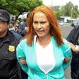 Marixa Lemus, alias "La Patrona," from Guatemala is escorted by police as she is presented to the media after her arrest for allegedly heading a criminal network involved in kidnapping and murder, in San Salvador on May 25, 2017