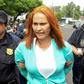 Marixa Lemus, alias "La Patrona," from Guatemala is escorted by police as she is presented to the media after her arrest for allegedly heading a criminal network involved in kidnapping and murder, in San Salvador on May 25, 2017