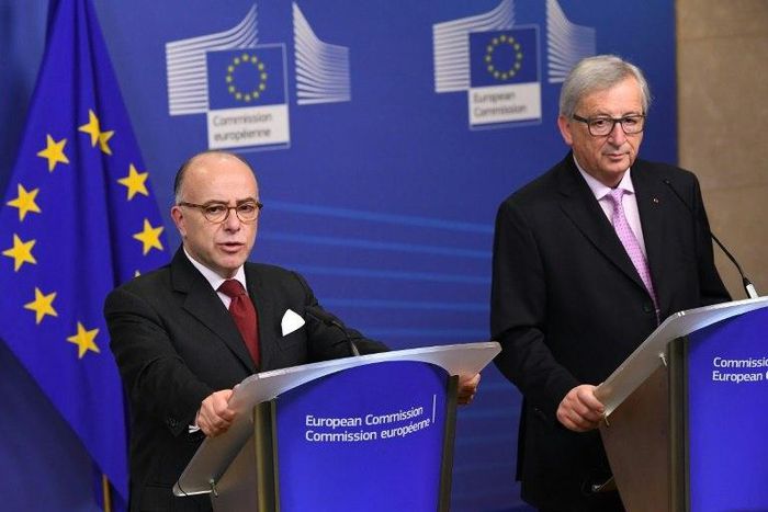 France's Prime Minister Bernard Cazeneuve (L) flanked by European Commission President Jean-Claude Juncker speaks in Brussels on February 6, 2017