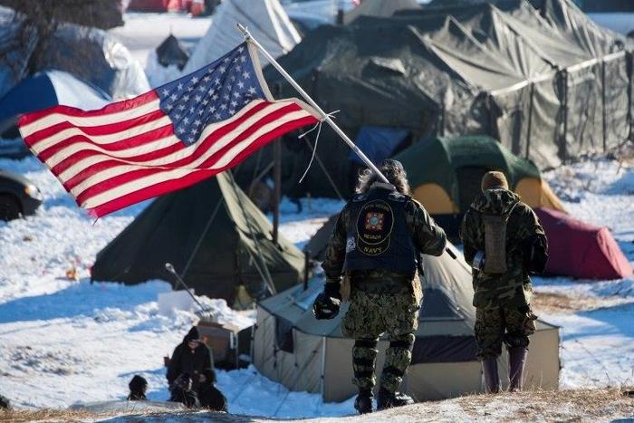 US military veterans joined protests against a controversial planned oil pipeline that have led the Army Corps of Engineers to rethink the route