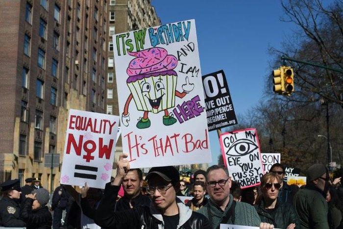 Protestors march down Central Park West in New York City during a "Not My President Day" rally on February 20, 2017