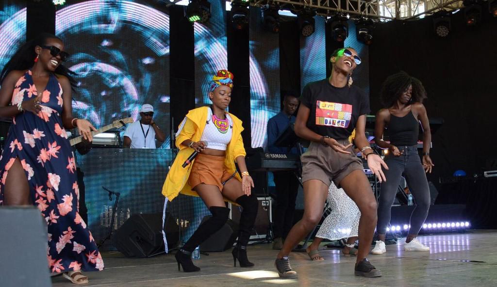 Phy dancing on stage with some female fans at the Koroga Festival (Image by Capital FM Kenya)