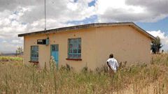 Ms Damaris Wambui Kamau, the mother of Dennis Ngaruiya, outside the house gifted to the family by President Uhuru Kenyatta but which she rejected saying it is substandard