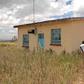 Ms Damaris Wambui Kamau, the mother of Dennis Ngaruiya, outside the house gifted to the family by President Uhuru Kenyatta but which she rejected saying it is substandard