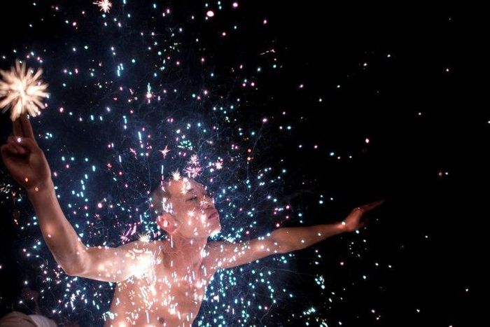 A Fangshan villager performs the 'eating flowers' ritual - bathing in a shower of scorching sparks - to wash away the taint of evil spirits