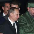 Then Cuban President Fidel Castro (R) welcomes Russian President Vladimir Putin to Jose Marti Airport in Havana on December 13, 2000