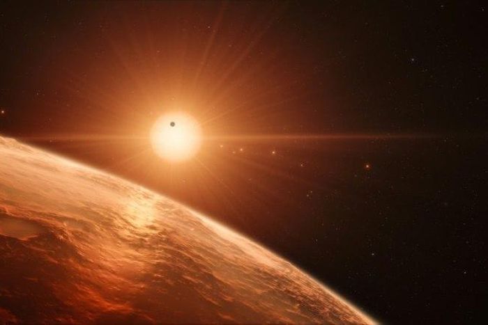 This handout artist’s impression shows the view just above the surface of one of the planets in the TRAPPIST-1 system