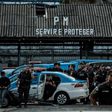 Military police officers gather as their relatives block the entrance to the police station in Rio de Janeiro on February 10, 2017