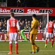 Arsenal's English midfielder Theo Walcott (R) watches his shot as he scores their second goal, his 100th goal for Arsenal, during the English FA Cup fifth round football match between Sutton United and Arsenal on February 20, 2017