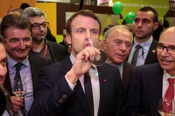 French presidential election frontrunner Emmanuel Macron (C) said he would forbid parliamentarians from employing family members, "to put an end to nepotism"
