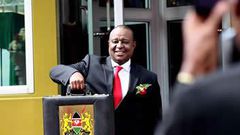 Finance Cabinet Secretary Henry Rotich poses with the traditional budget briefcase outside Parliament