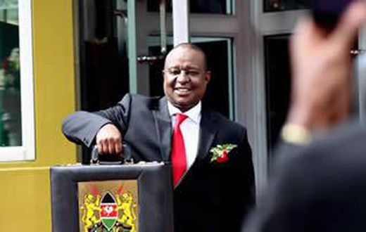 Finance Cabinet Secretary Henry Rotich poses with the traditional budget briefcase outside Parliament