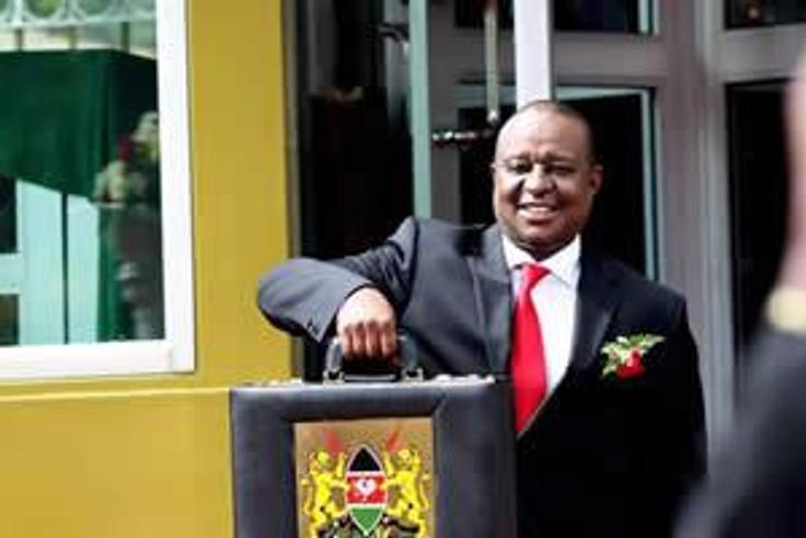 Finance Cabinet Secretary Henry Rotich poses with the traditional budget briefcase outside Parliament
