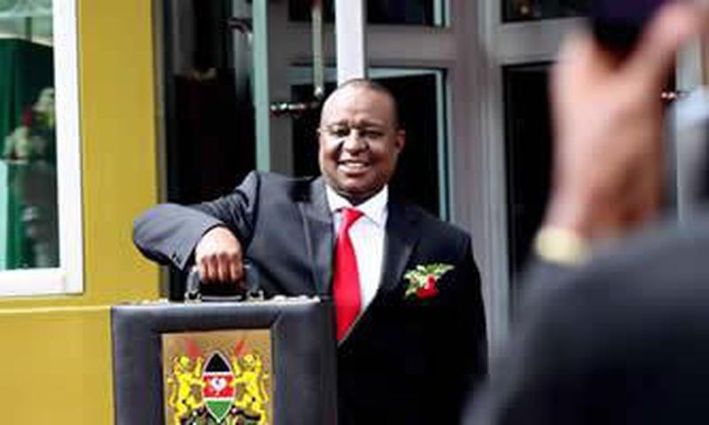 Finance Cabinet Secretary Henry Rotich poses with the traditional budget briefcase outside Parliament