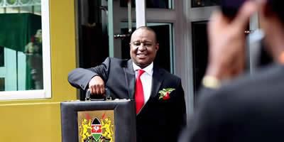 Finance Cabinet Secretary Henry Rotich poses with the traditional budget briefcase outside Parliament