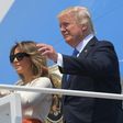 Donald Trump and his wife Melania wave before boarding Air Force One for his first trip abroad as US president