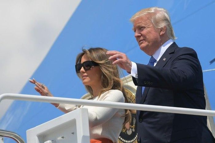 Donald Trump and his wife Melania wave before boarding Air Force One for his first trip abroad as US president