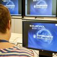 A Europol police agent looks at the onscreen logo of a new website launched by Europol at the Europol headquarters in The Hague on May 31, 2017