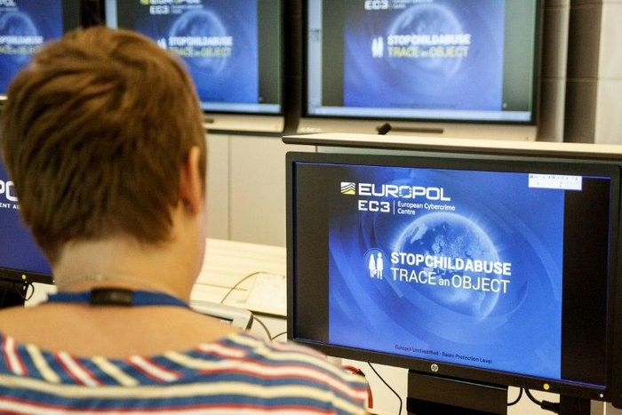 A Europol police agent looks at the onscreen logo of a new website launched by Europol at the Europol headquarters in The Hague on May 31, 2017