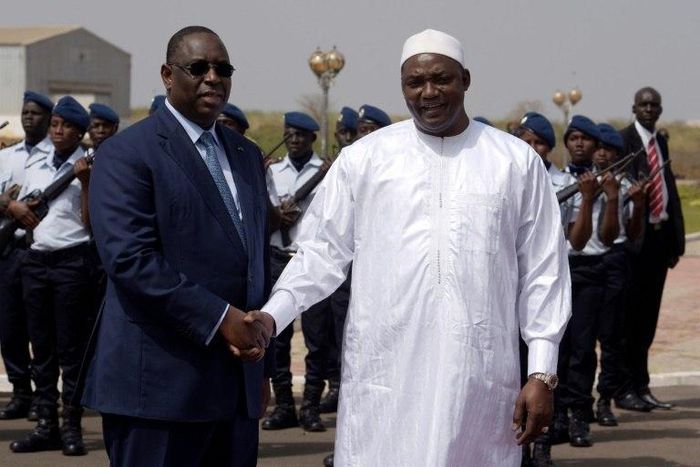 Senegalese president Macky Sall (L) shakes hands with his Gambian counterpart Adama Barrow upon his arrival at Dakar airport for a three-day official visit to Senegal, on March 2, 2017