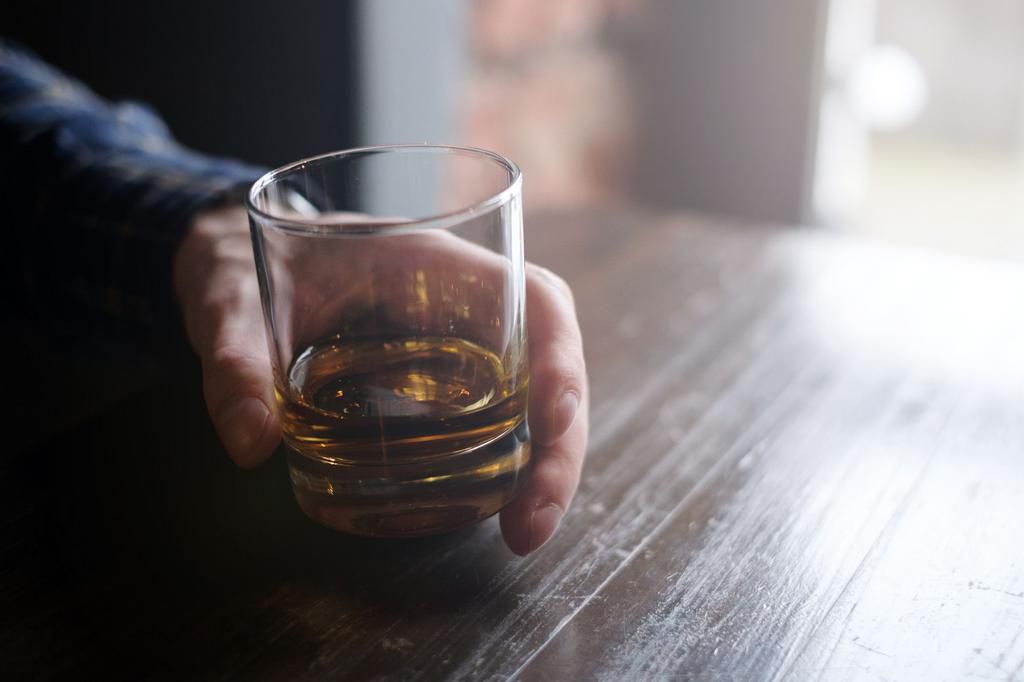 Man holding glass of whisky