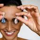 A model poses with the "The Apollo Blue" and "The Artemis Pink" diamonds, mounted as earrings, sold for a collective $57.4-million