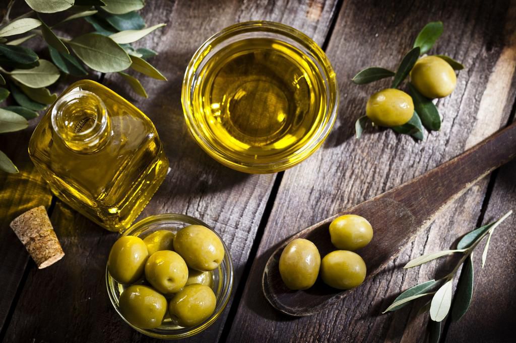 Olive oil and green olives shot from above